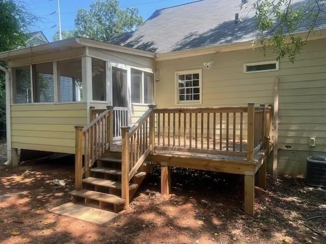 a view of a yard with plants and trees