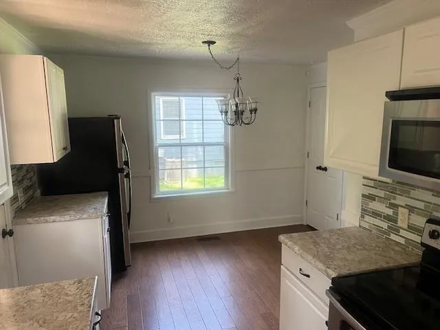 a kitchen with a stove and a refrigerator