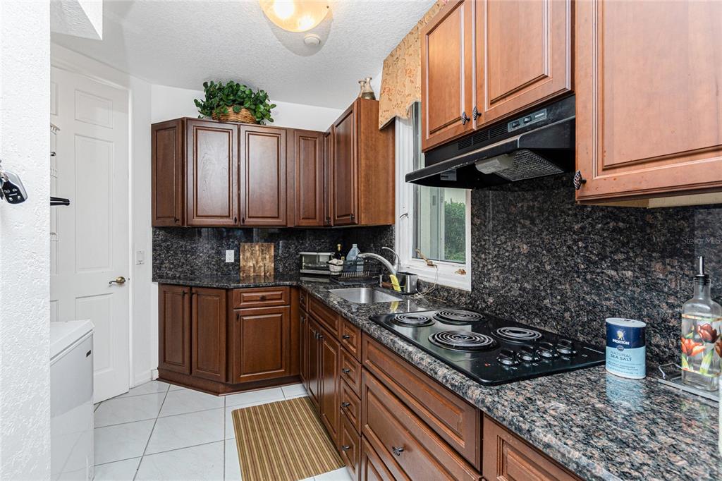 202 George Road Southeast Port Charlotte, FL 33952 - Photo 19 of 100 a kitchen with stainless steel appliances granite countertop a stove sink and cabinets