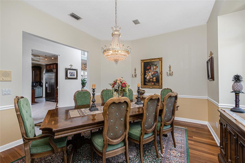 202 George Road Southeast Port Charlotte, FL 33952 - Photo 21 of 100 a dining room with furniture a chandelier and wooden floor