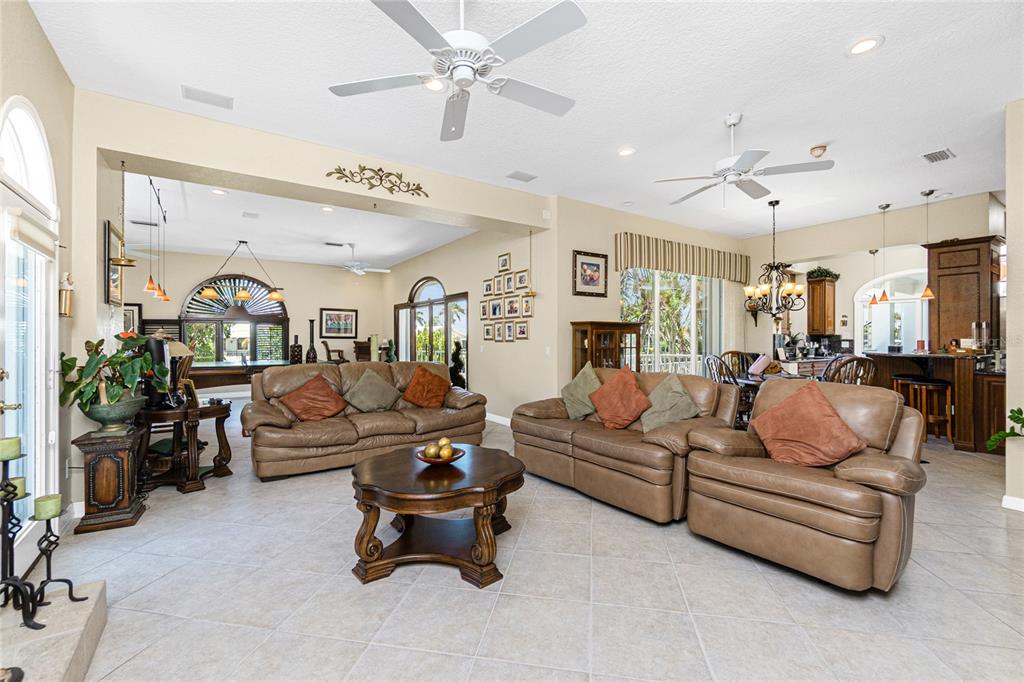 202 George Road Southeast Port Charlotte, FL 33952 - Photo 25 of 100 a living room with furniture kitchen view and a chandelier