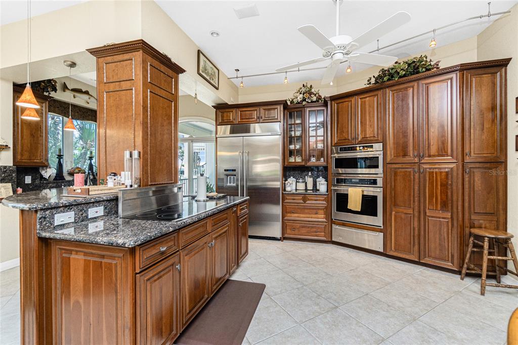 202 George Road Southeast Port Charlotte, FL 33952 - Photo 34 of 100 a kitchen with stainless steel appliances granite countertop a refrigerator a stove and a sink