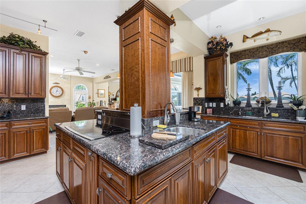 202 George Road Southeast Port Charlotte, FL 33952 - Photo 38 of 100 a kitchen with stainless steel appliances granite countertop a sink a stove and a wooden cabinets