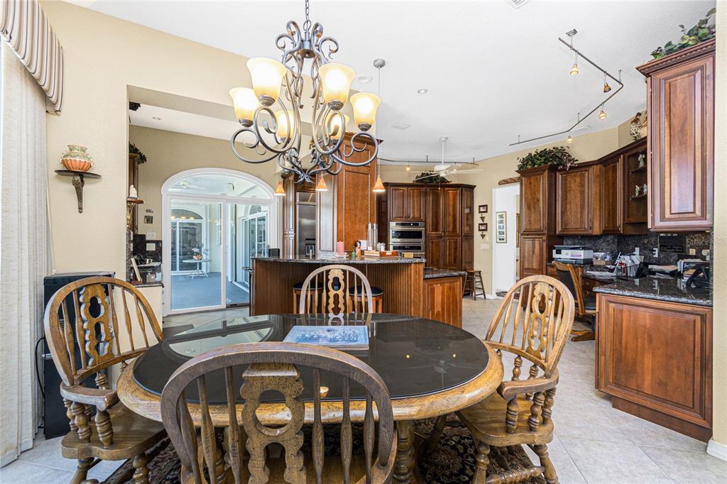 202 George Road Southeast Port Charlotte, FL 33952 - Photo 42 of 100 a view of a dining room with furniture and chandelier