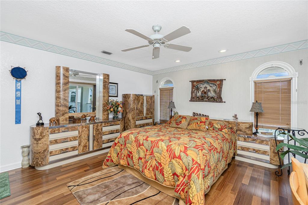 202 George Road Southeast Port Charlotte, FL 33952 - Photo 50 of 100 a bed room with a bed and a chandelier