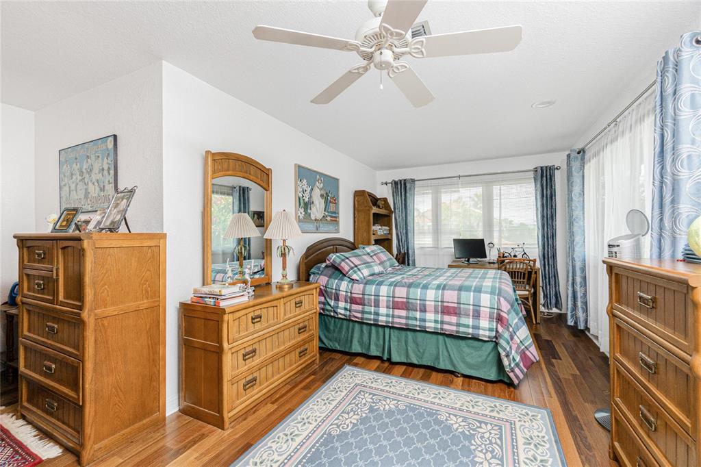 202 George Road Southeast Port Charlotte, FL 33952 - Photo 59 of 100 a bedroom with a bed and a chandelier