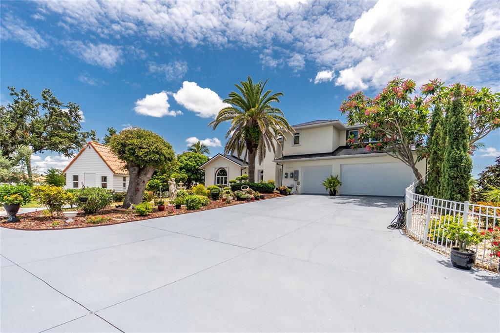 202 George Road Southeast Port Charlotte, FL 33952 - Photo 89 of 100 a front view of a house with a yard and a garage