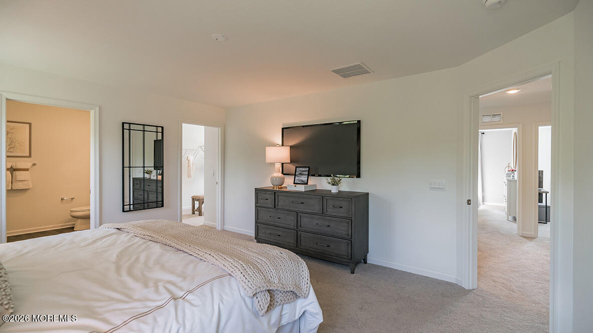 48 East 3rd Street Howell, NJ 07731 - Photo 14 of 20 a bedroom with a bed and a flat screen tv