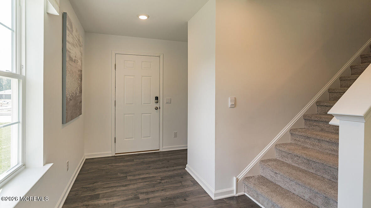 48 East 3rd Street Howell, NJ 07731 - Photo 4 of 20 a view of entryway with wooden floor and stairs