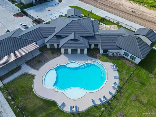 an aerial view of a house with swimming pool and outdoor space