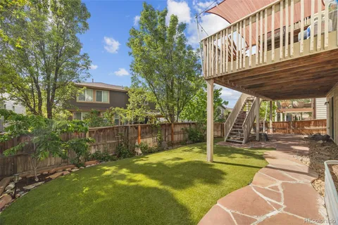 a view of a backyard with swimming pool
