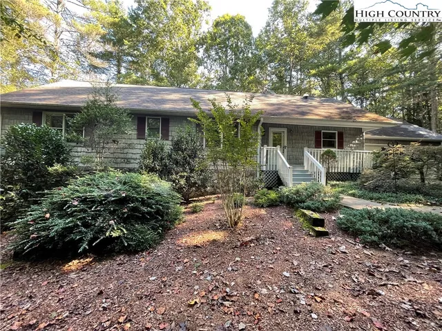 a view of a house with a garden and plants