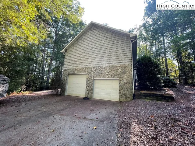 a view of a house with a yard and garage