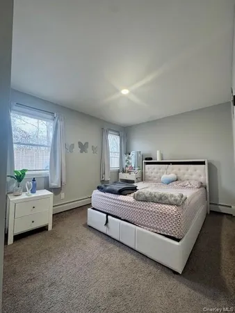 a spacious bedroom with a bed and a window