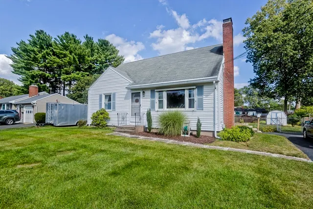 a view of a house with a yard and sitting area