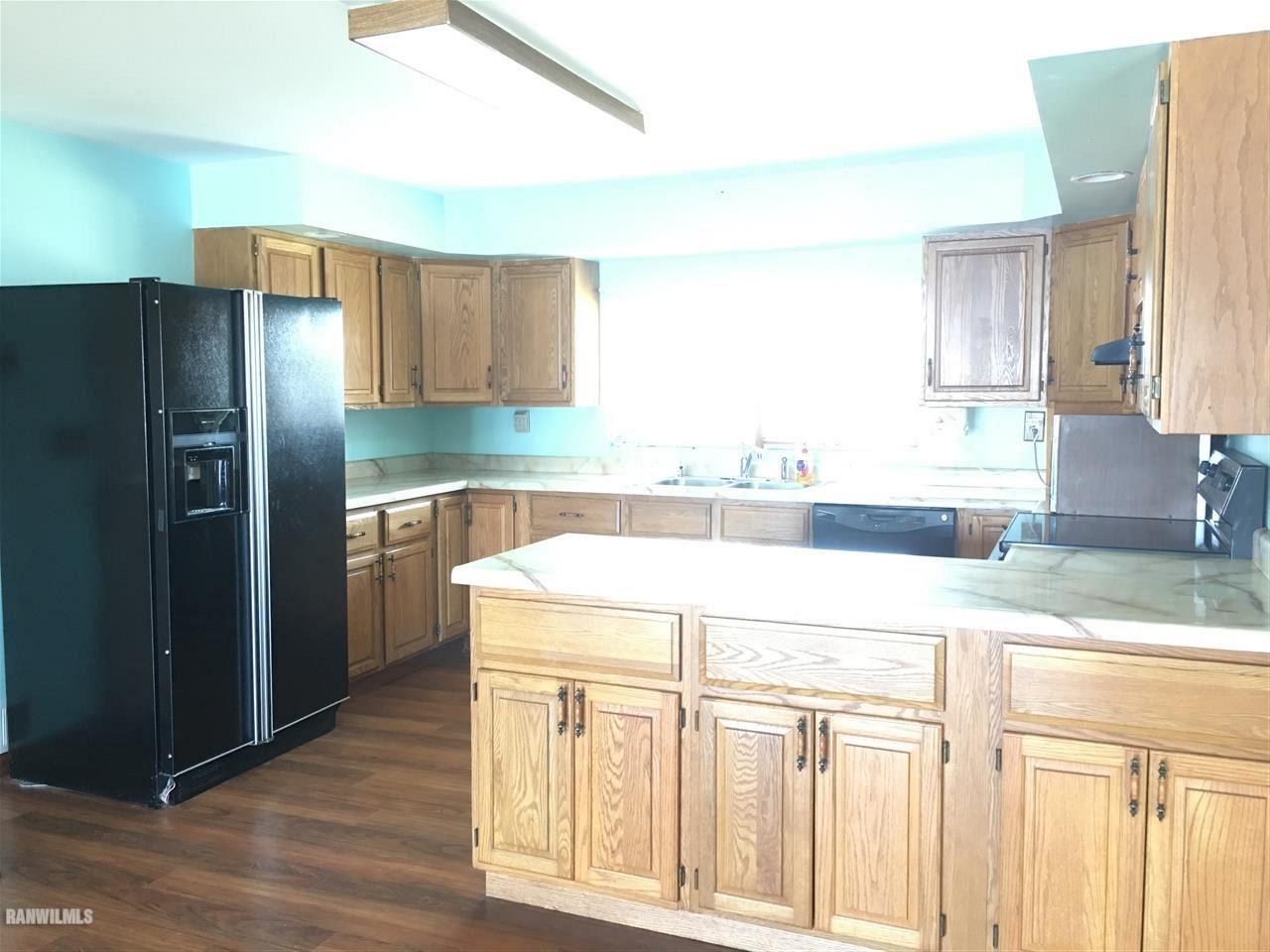 5694 Riverview Road Thomson, IL 61285 - Photo 12 of 25 a kitchen with a sink a refrigerator and a cabinets