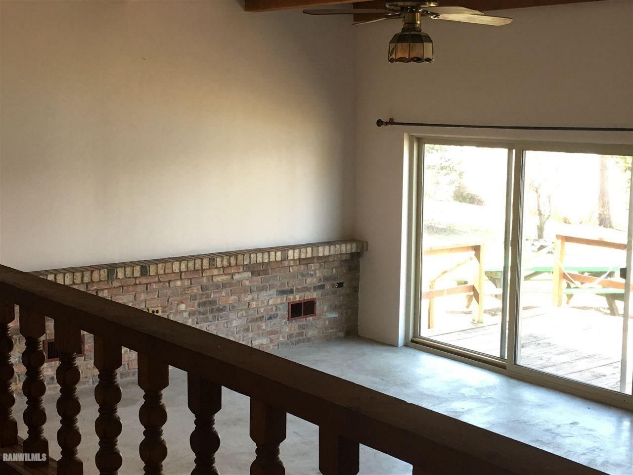 5694 Riverview Road Thomson, IL 61285 - Photo 14 of 25 a view of wooden floor and a floor to ceiling window