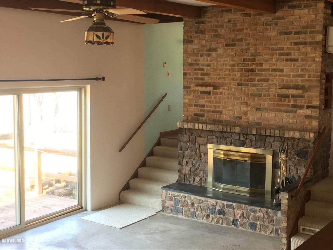 5694 Riverview Road Thomson, IL 61285 - Photo 15 of 25 a view of a livingroom with an empty space and a fireplace