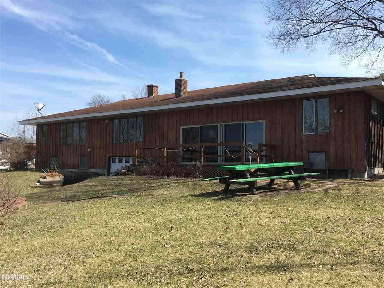 5694 Riverview Road Thomson, IL 61285 - Photo 2 of 25 a backyard of a house with yard and garage