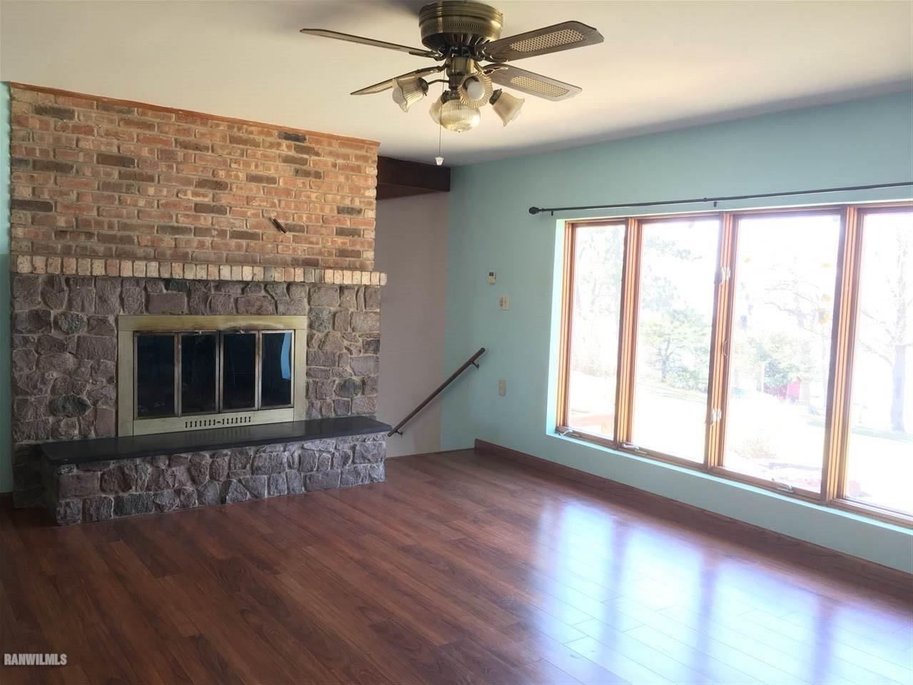 5694 Riverview Road Thomson, IL 61285 - Photo 4 of 25 a view of an empty room with wooden floor and a window