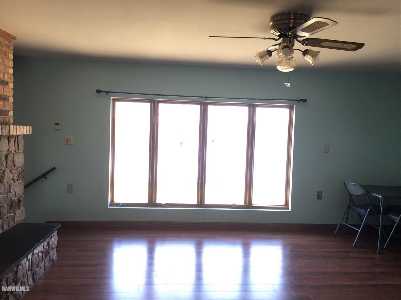 5694 Riverview Road Thomson, IL 61285 - Photo 6 of 25 a view of an empty room with wooden floor and a window