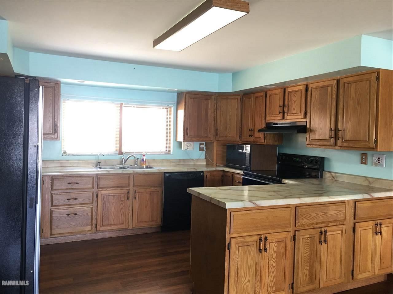 5694 Riverview Road Thomson, IL 61285 - Photo 8 of 25 a kitchen with granite countertop a sink stainless steel appliances and cabinets