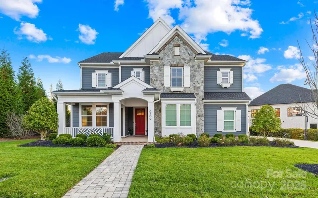 a view of a house with swimming pool and sitting area