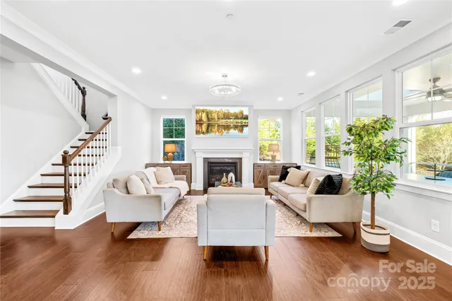 a kitchen with stainless steel appliances kitchen island granite countertop a dining table chairs and granite counter tops