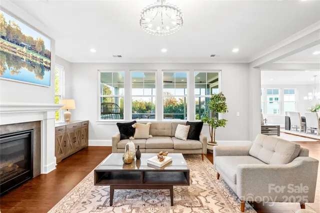 a kitchen with a white stove top oven and white cabinets with wooden floor