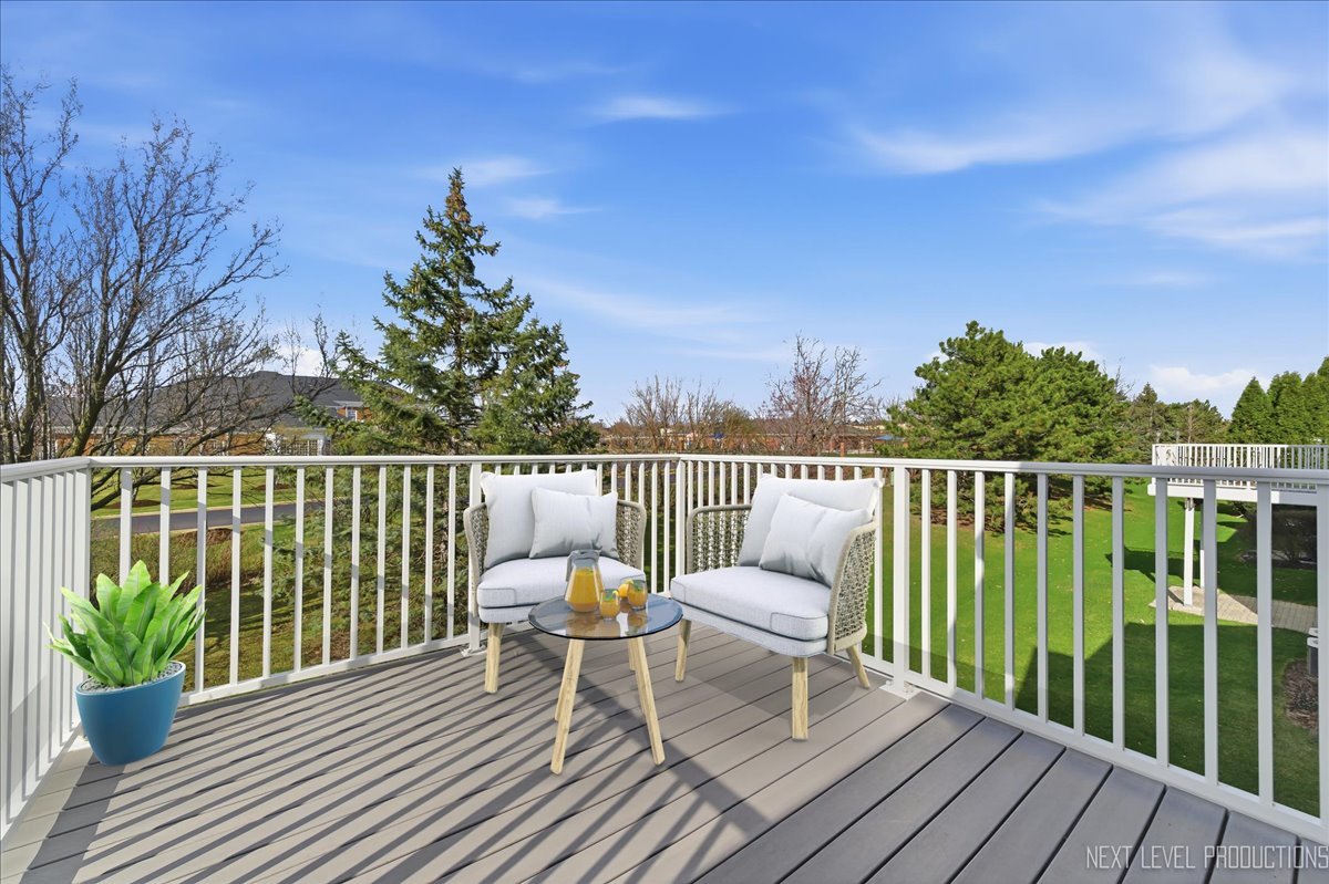 1102 Delta Drive, Unit 1102 Elgin, IL 60123 - Photo 13 of 29 a balcony with wooden floor table and chairs