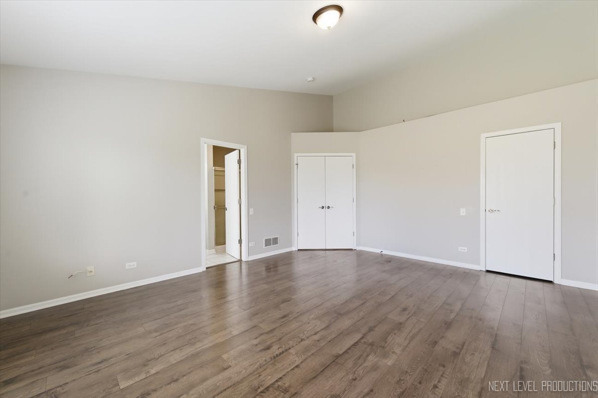 1102 Delta Drive, Unit 1102 Elgin, IL 60123 - Photo 18 of 29 an empty room with wooden floor & cabinet