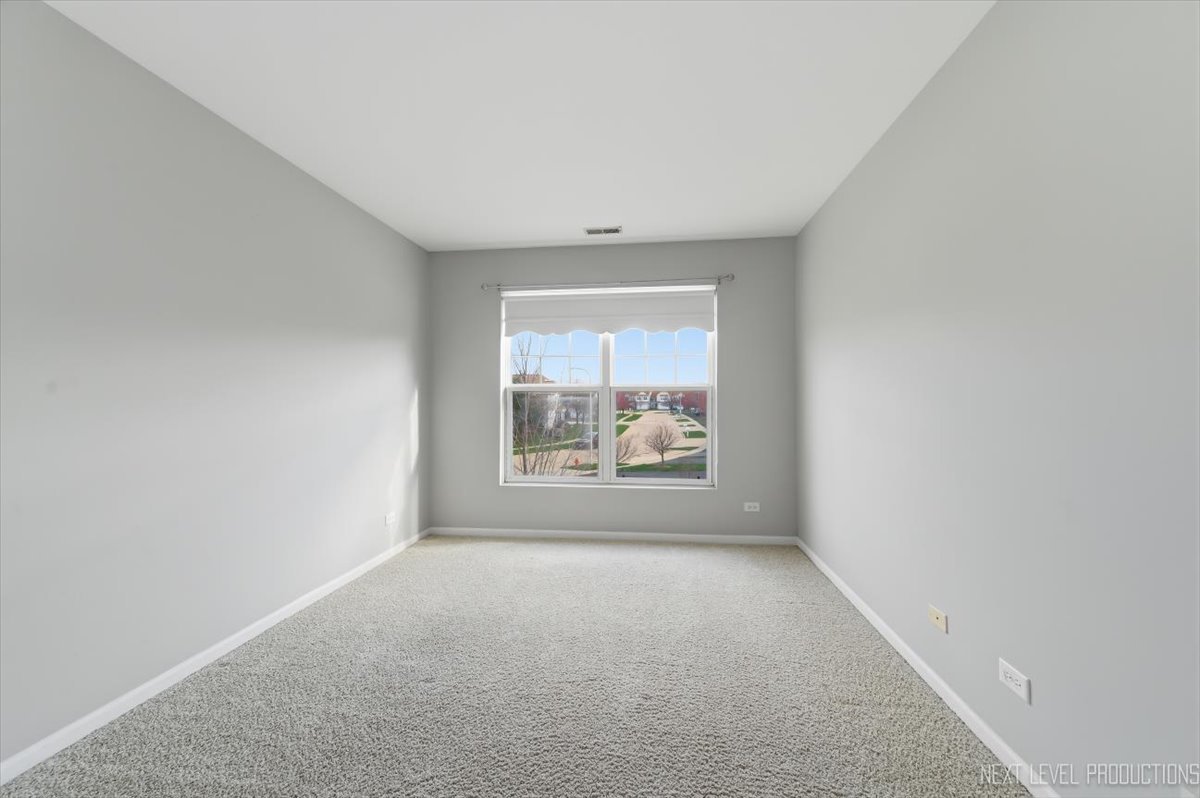 1102 Delta Drive, Unit 1102 Elgin, IL 60123 - Photo 22 of 29 an empty room with windows