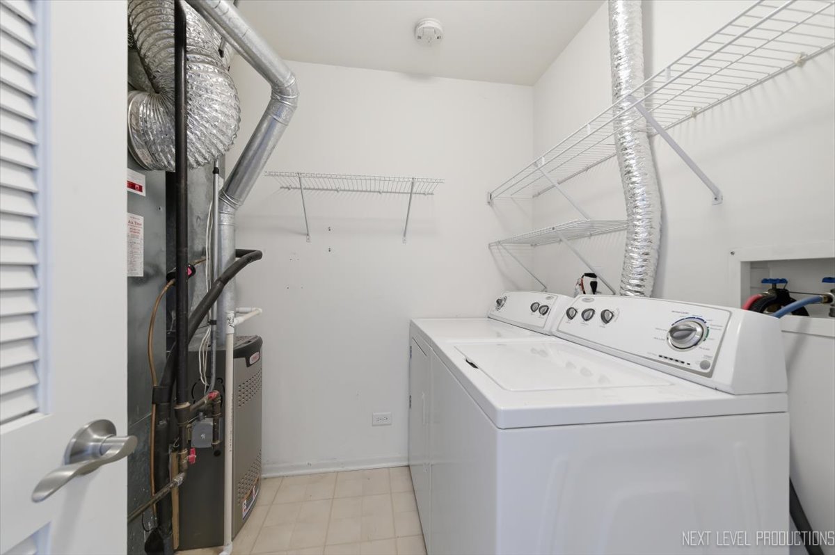 1102 Delta Drive, Unit 1102 Elgin, IL 60123 - Photo 27 of 29 a utility room with dryer and washer