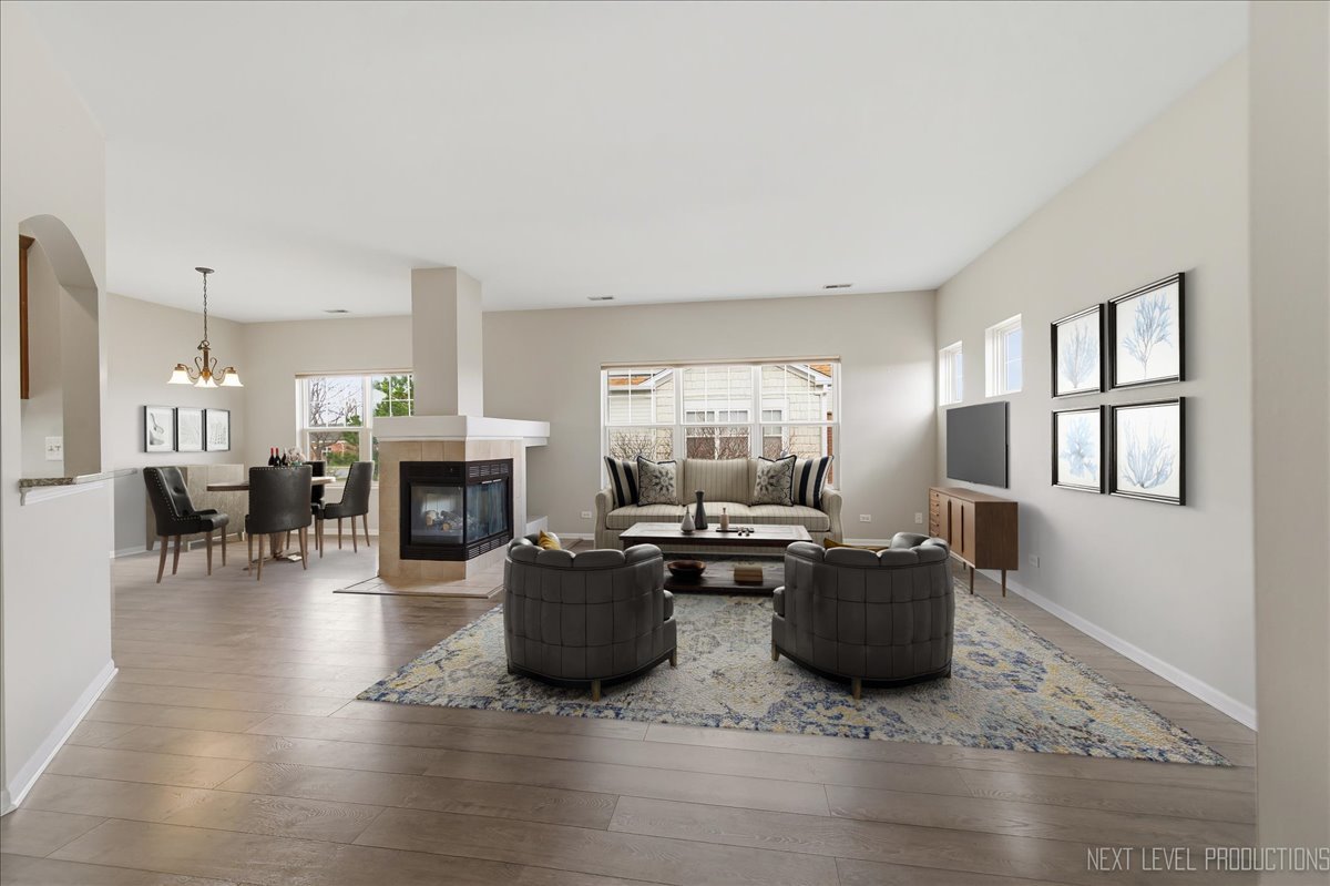 1102 Delta Drive, Unit 1102 Elgin, IL 60123 - Photo 4 of 29 a living room with furniture a fireplace and a table
