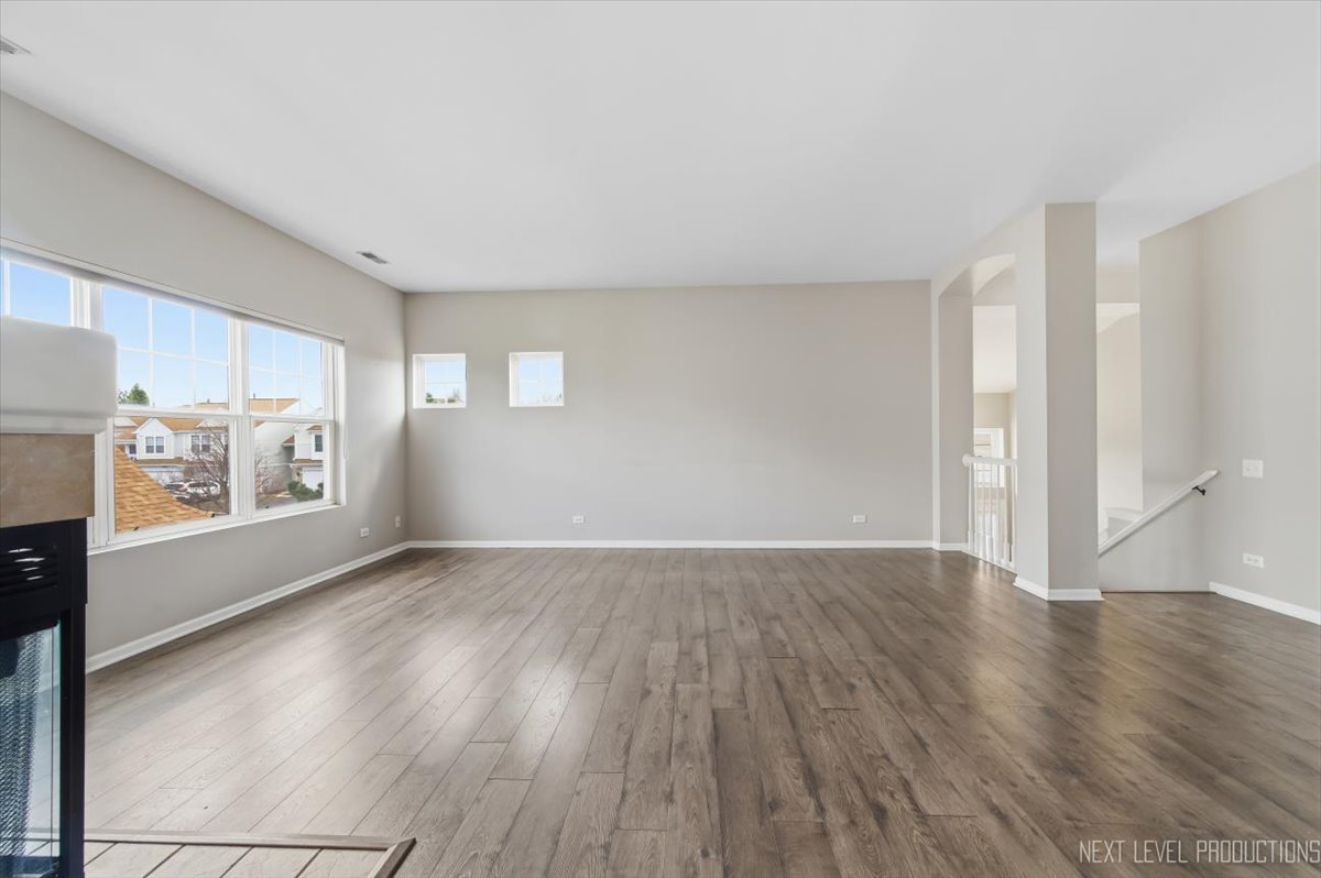 1102 Delta Drive, Unit 1102 Elgin, IL 60123 - Photo 10 of 29 an empty room with wooden floor and windows