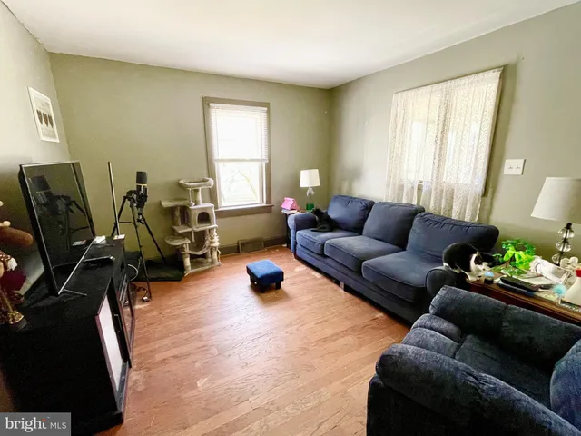 a living room with furniture a window and gym equipment