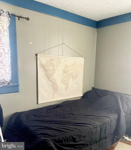 a bed sitting in a bedroom next to a window