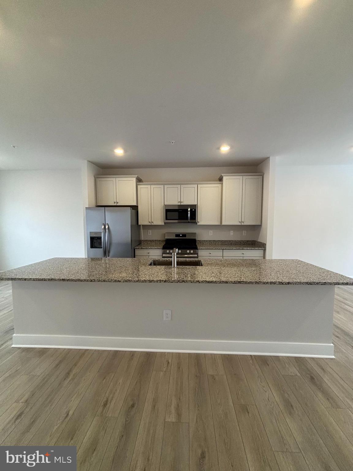 7234 Contee Road Laurel, MD 20707 - Photo 2 of 9 a view of kitchen with stainless steel appliances granite countertop a stove a sink and a refrigerator