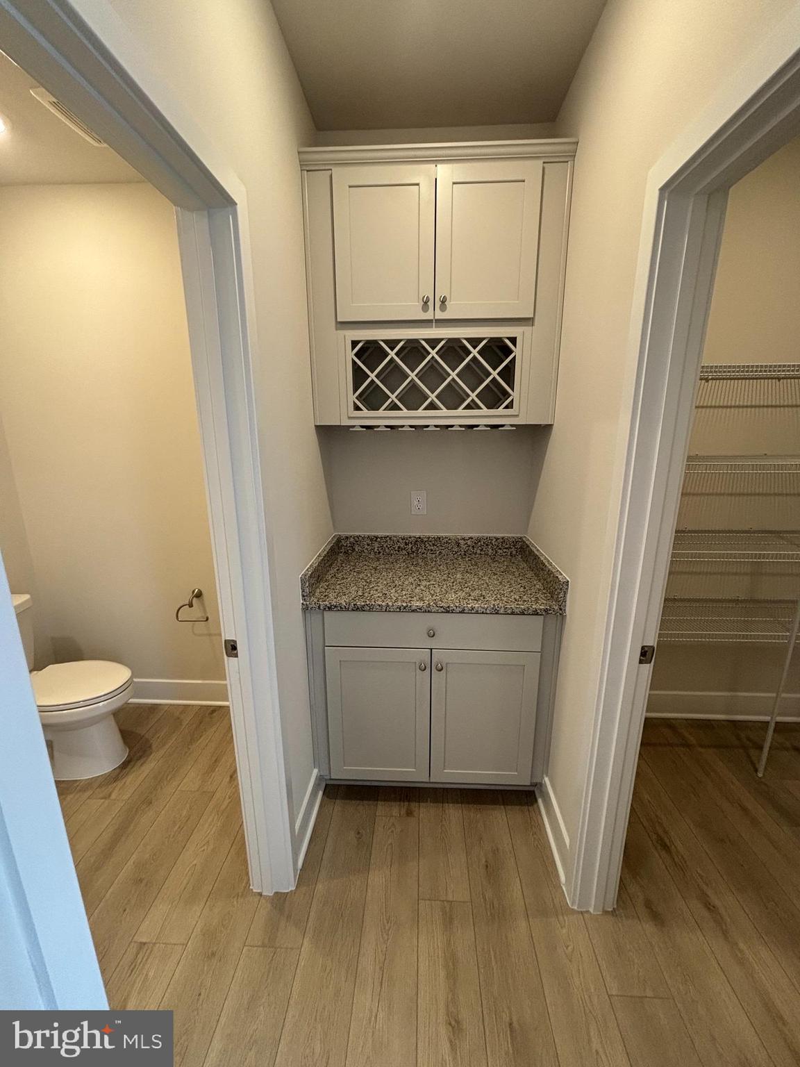 7234 Contee Road Laurel, MD 20707 - Photo 3 of 9 a bathroom with a granite countertop sink and a toilet