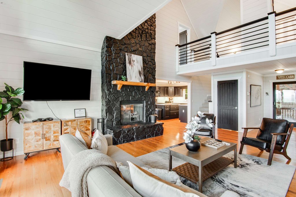 231 Sunrock Mountain Trail Blue Ridge, GA 30513 - Photo 11 of 61 a living room with furniture a flat screen tv and a fireplace