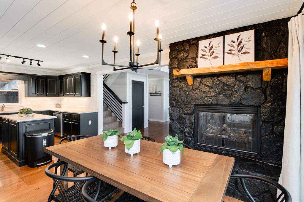 231 Sunrock Mountain Trail Blue Ridge, GA 30513 - Photo 14 of 61 a kitchen with a table chairs and refrigerator