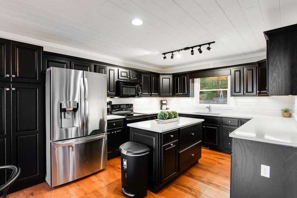 231 Sunrock Mountain Trail Blue Ridge, GA 30513 - Photo 15 of 61 a kitchen with stainless steel appliances granite countertop a sink stove and refrigerator