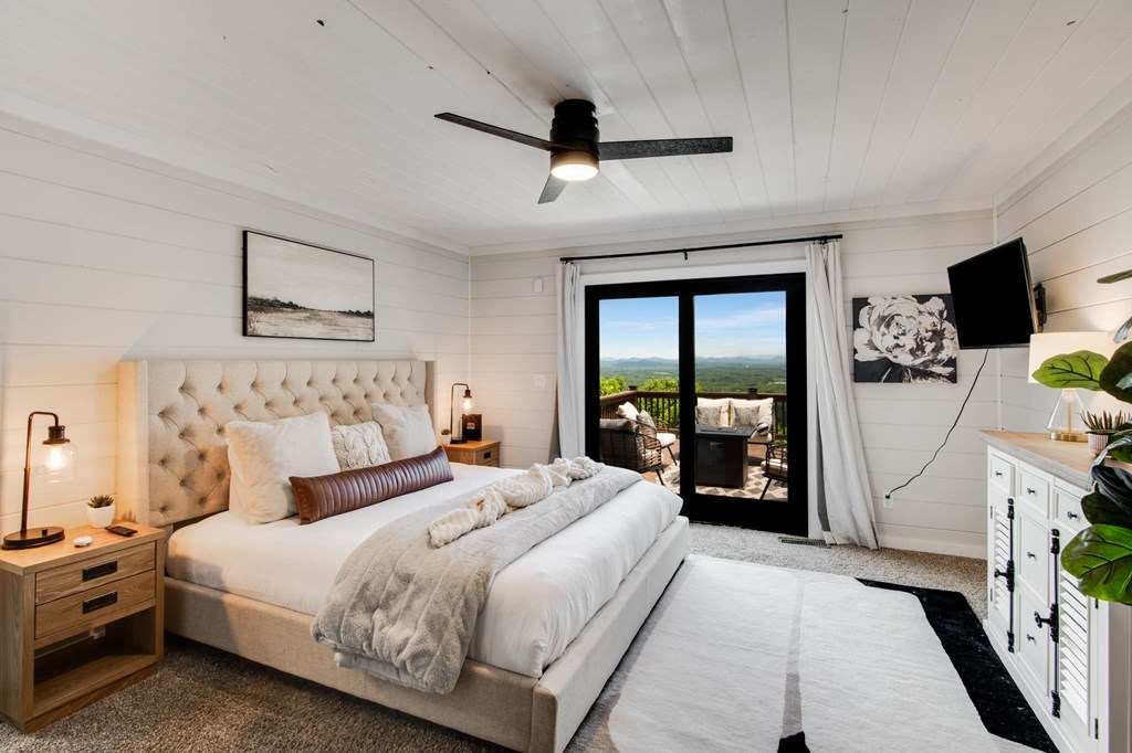 231 Sunrock Mountain Trail Blue Ridge, GA 30513 - Photo 29 of 61 a bedroom with bed and a flat tv screen on dresser