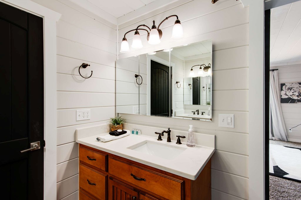 231 Sunrock Mountain Trail Blue Ridge, GA 30513 - Photo 34 of 61 a bathroom with a sink vanity toilet and shower