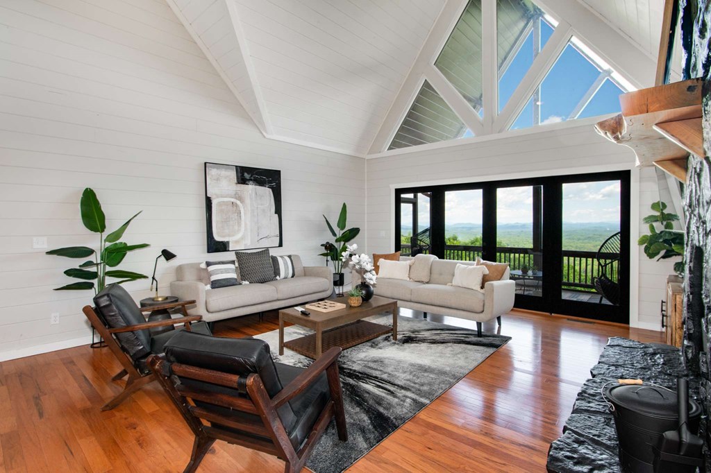 231 Sunrock Mountain Trail Blue Ridge, GA 30513 - Photo 9 of 61 a living room with furniture large wooden floor and a potted plant