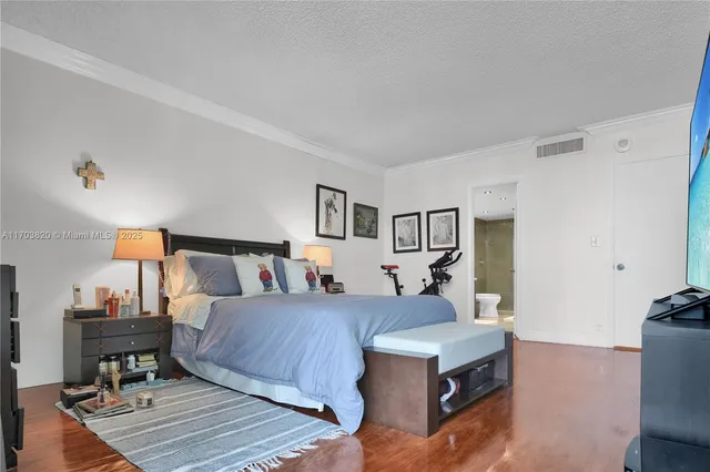 a dining room with stainless steel appliances a dining table chairs and a refrigerator