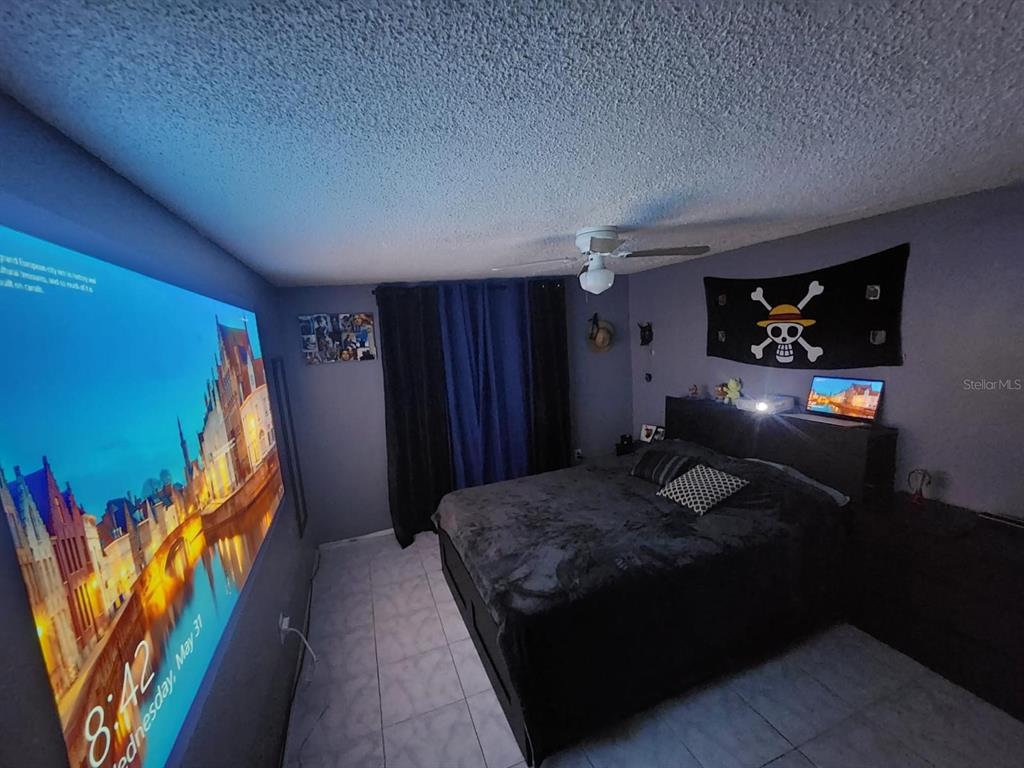 Undisclosed Address New Port Richey, FL 34652 - Photo 25 of 25 a bedroom with a bed dresser and a flat tv screen