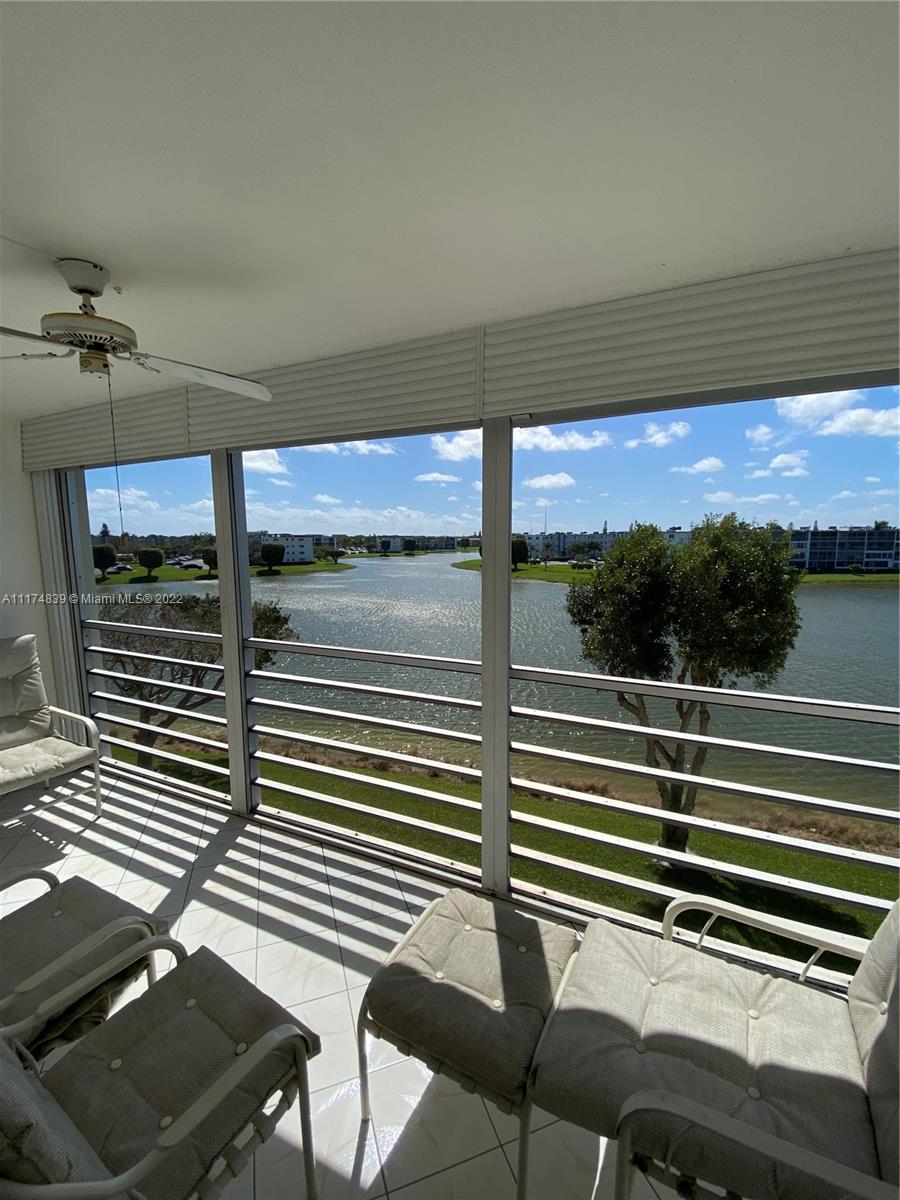 4034 Rexford B, Unit 4034 Boca Raton, FL 33434 - Photo 13 of 15 a view of a chairs and table in the balcony
