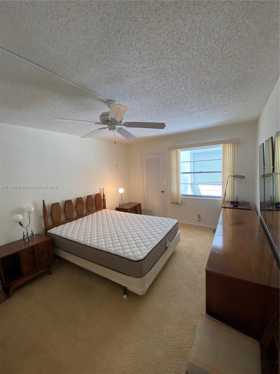 4034 Rexford B, Unit 4034 Boca Raton, FL 33434 - Photo 15 of 15 a bed room with a bed and a window