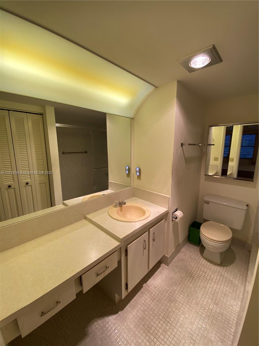4034 Rexford B, Unit 4034 Boca Raton, FL 33434 - Photo 6 of 15 a bathroom with a granite countertop sink and a mirror